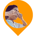 The image shows an individual performing the Shanmukhi mudra. The Shanmukhi mudra is a yogic hand gesture where the thumbs are used to close the ears, the index fingers close the eyes, the middle fingers close the nostrils, and the ring and little fingers press above and below the lips, respectively. The image depicts a specific yogic practice aimed at sensory withdrawal and inner focus, which is significant in meditation and mindfulness practices.